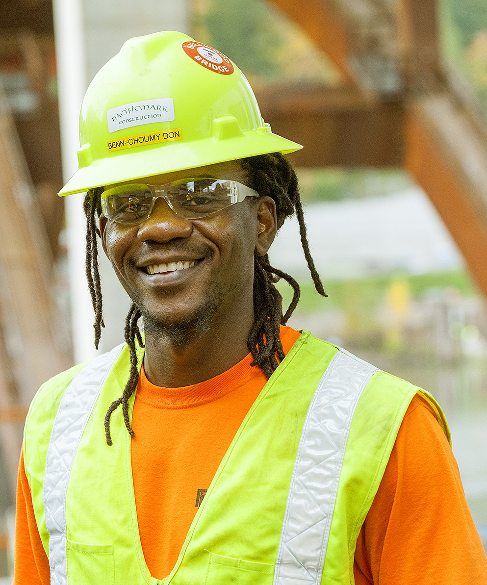A carpentry apprentice at work on a construction site